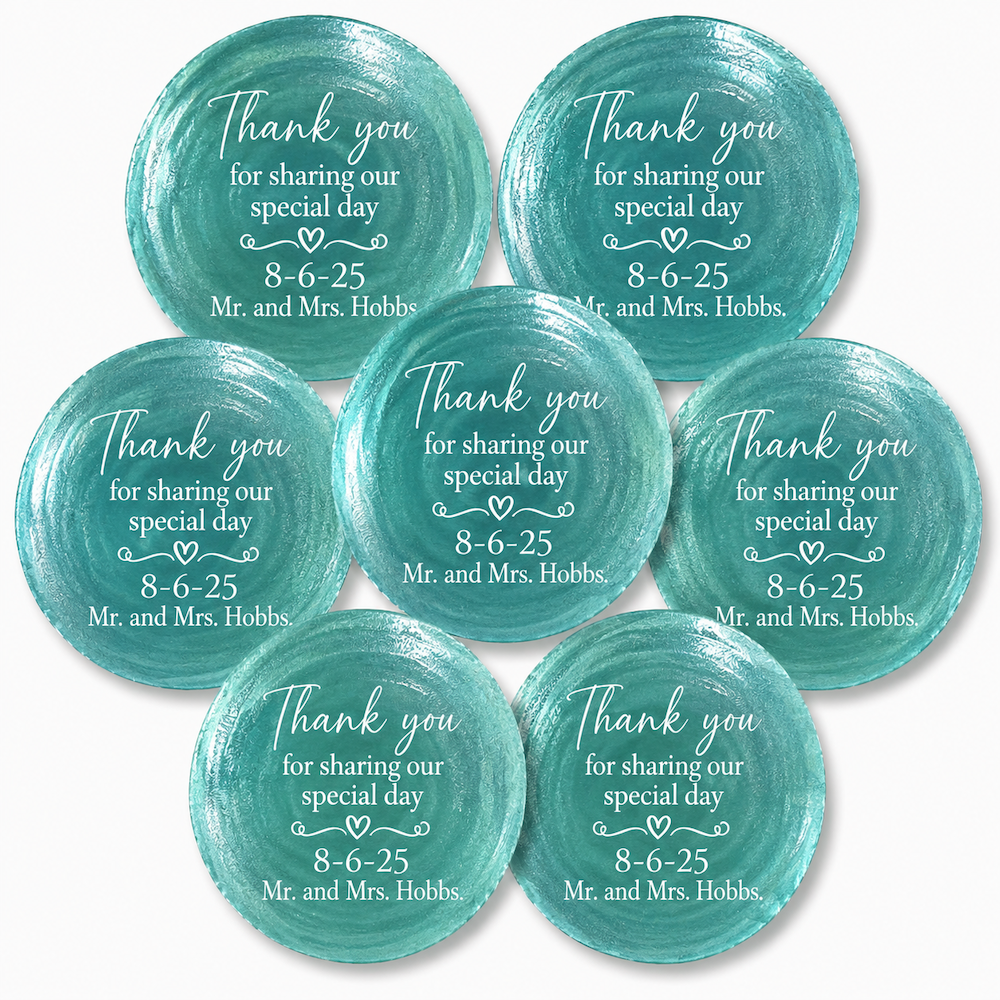 Seven round teal watercolor-style shell place cards with white printed text reading 'Thank you for sharing our special day 8-6-25 Mr. and Mrs.