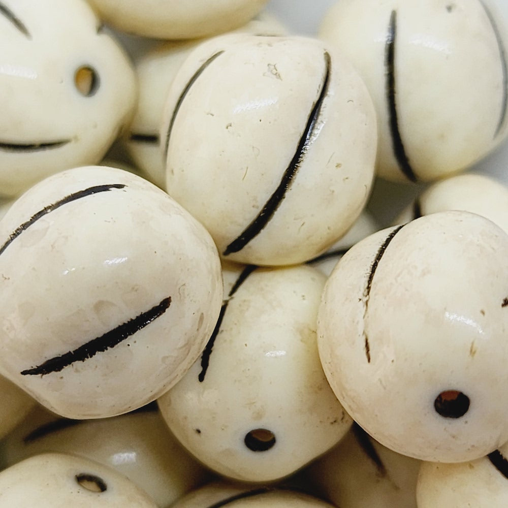 close up stone look beads with large threading hole and a glossy surface
