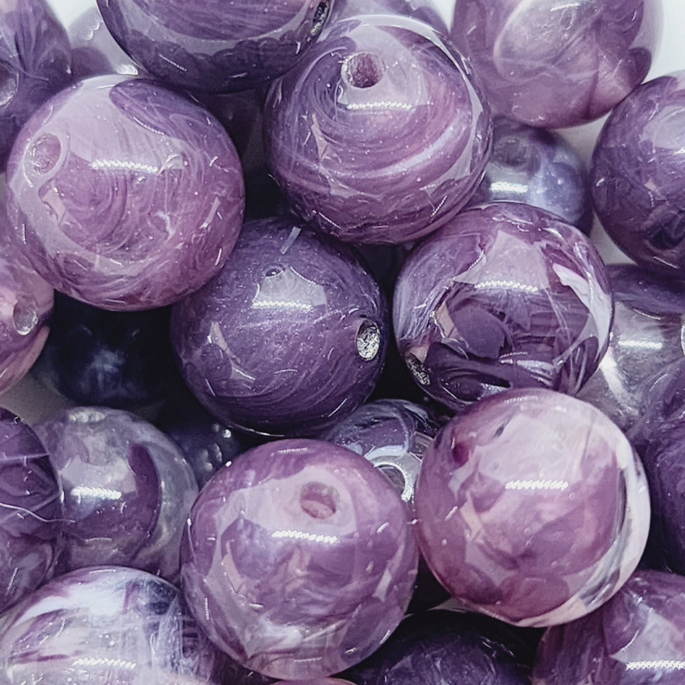 Amethyst purple gemstone style acrylic beads resembling real gemstones, with visible threading holes for crafting jewelry on a white background, used for crafting and jewelry making.
