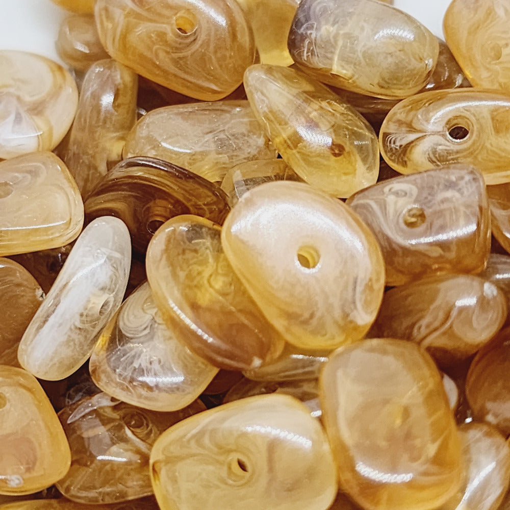 jasper brown gemstone style acrylic beads with visible threading holes for crafting jewelry on a white background