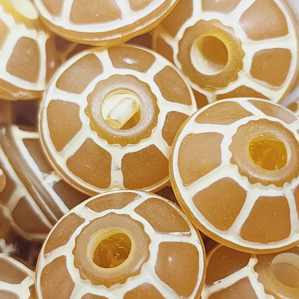 A collection of vintage orange and white lucite beads with a baroque pattern, reminiscent of a turtle's shell, used for crafting jewelry such as necklaces and bracelets.
