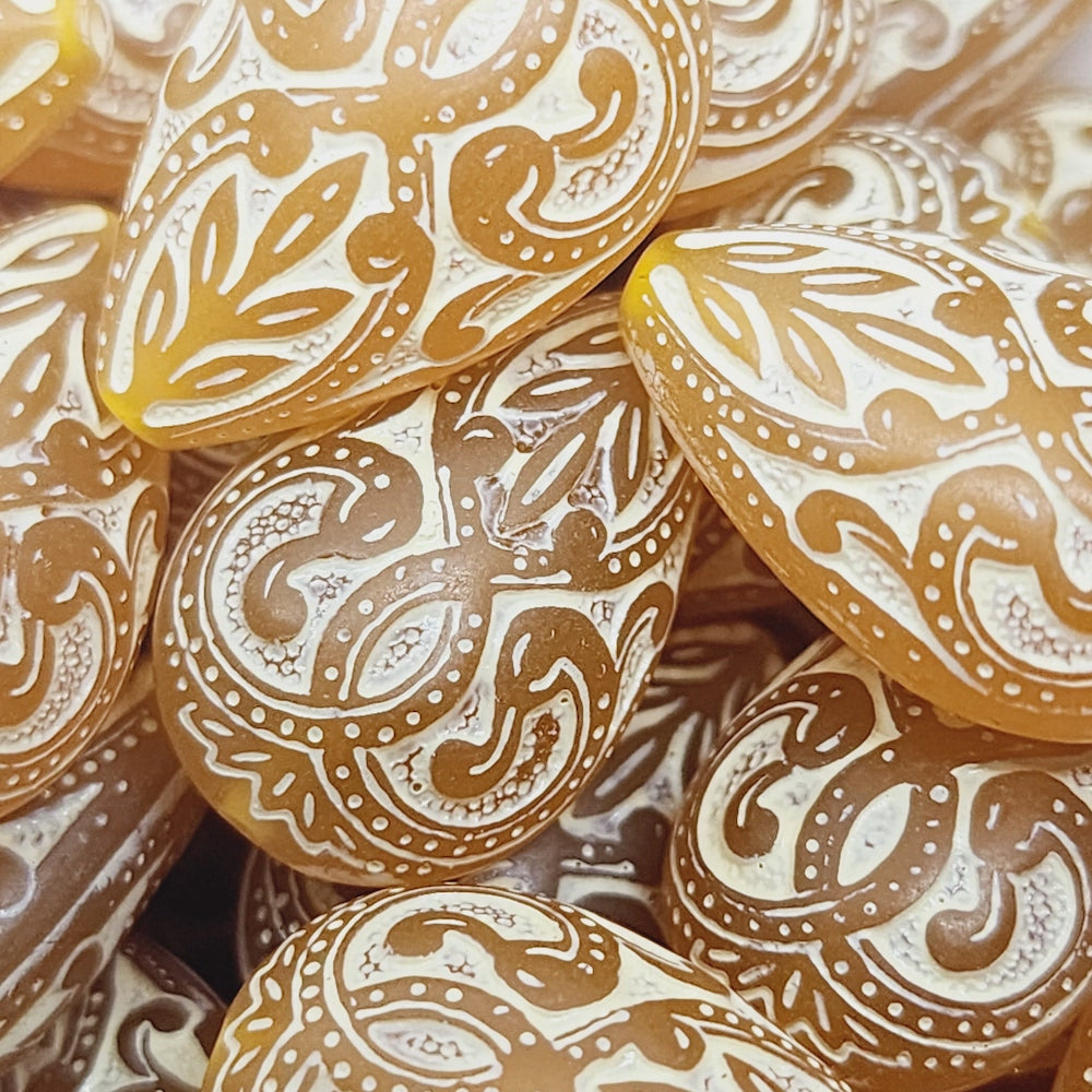 baroque vintage transparent orange drop beads with intricate orange and white designs showing visible holes for threading jewelry and earrings