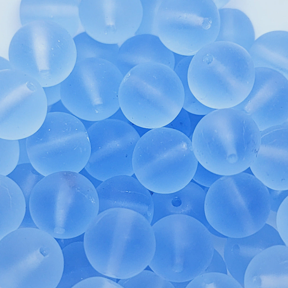 light blue frosted glass beads showing a threading hole for jewelery making