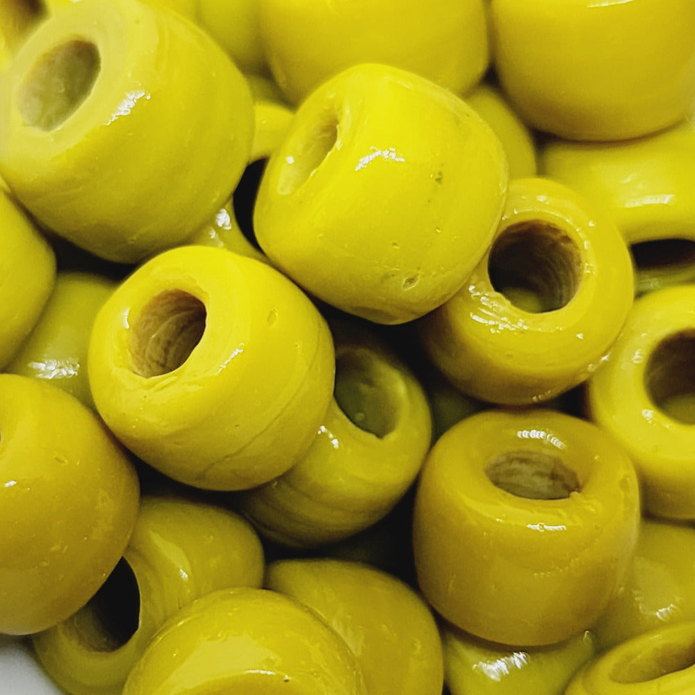 A collection of authentic glass Indian pony beads showing large holes for the purpose of making jewelry or decorations