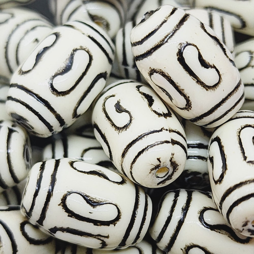 a group of vintage acrylic lucite beads with black etched designs for the purpose of making jewelry