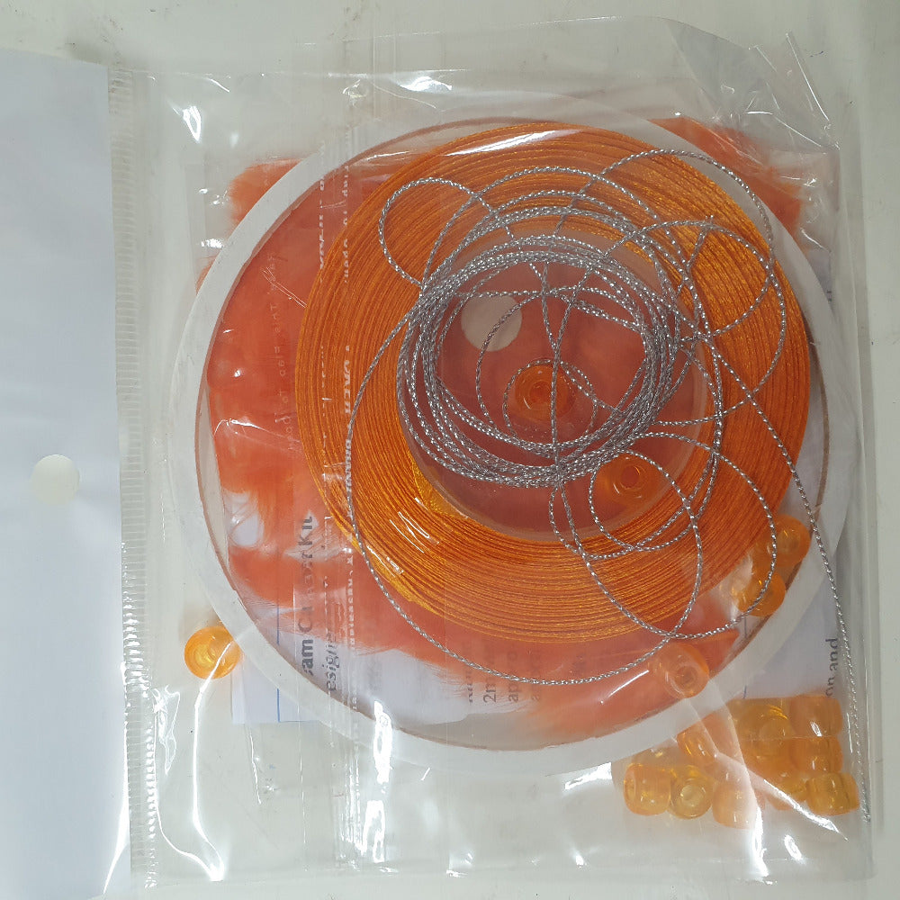 close up photo of a packed kit with written instructions showing colours of items inside the clear cellophane bag