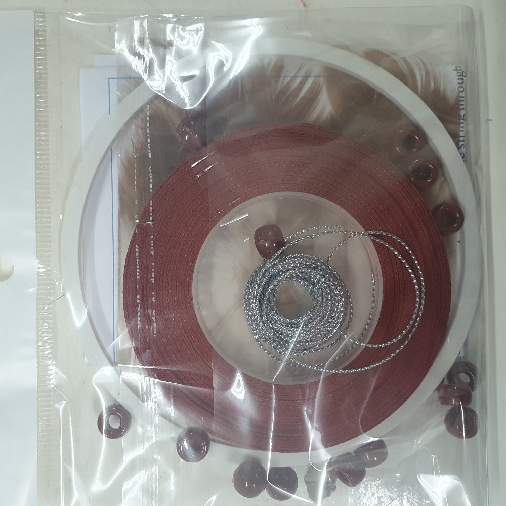 close up photo of a packed kit with written instructions showing colours of items inside the clear cellophane bag