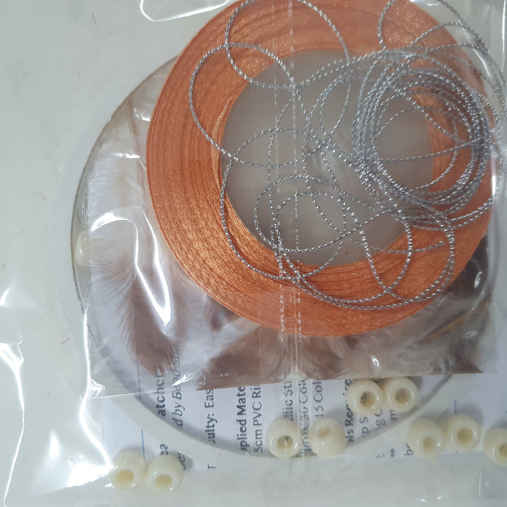 close up photo of a packed kit with written instructions showing colours of items inside the clear cellophane bag
