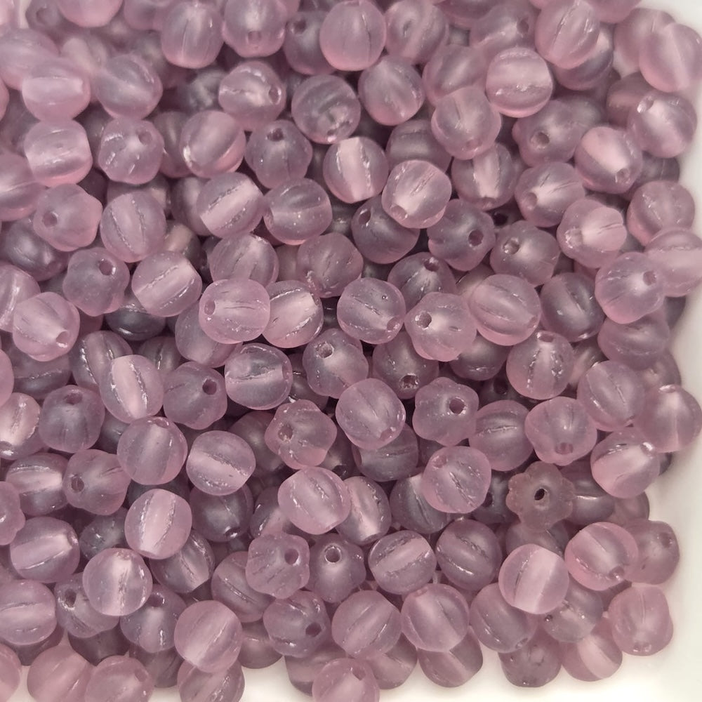 Close-up of purple beads on a white background