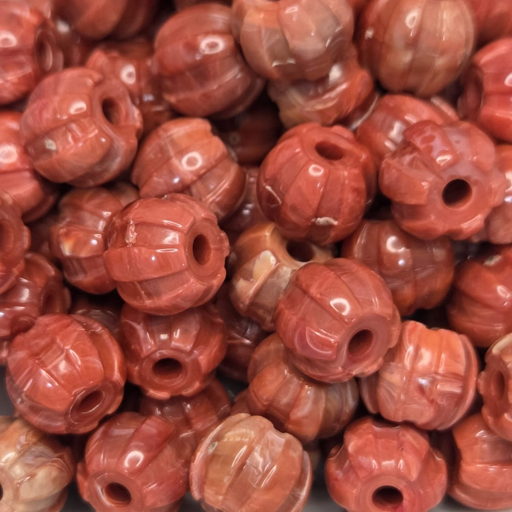 Close-up of red-orange beads with a textured surface