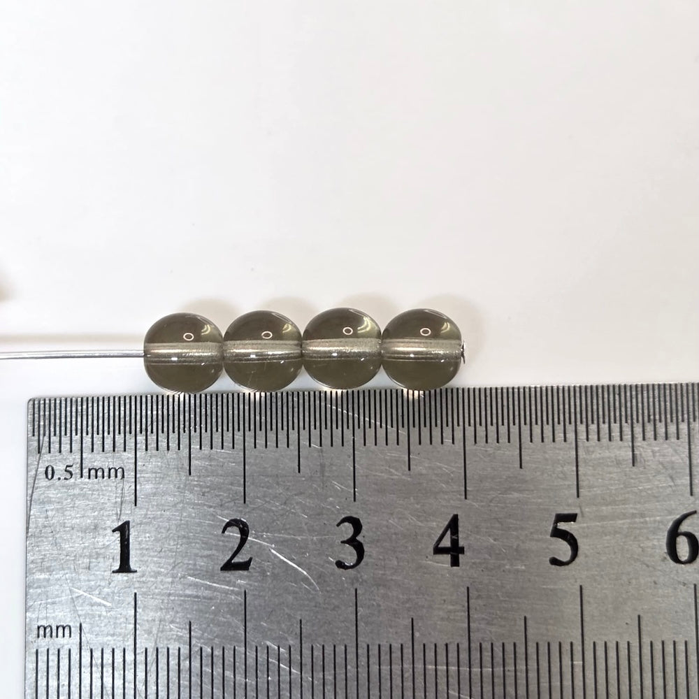 grey transparent round beads with a ruler to show proportion