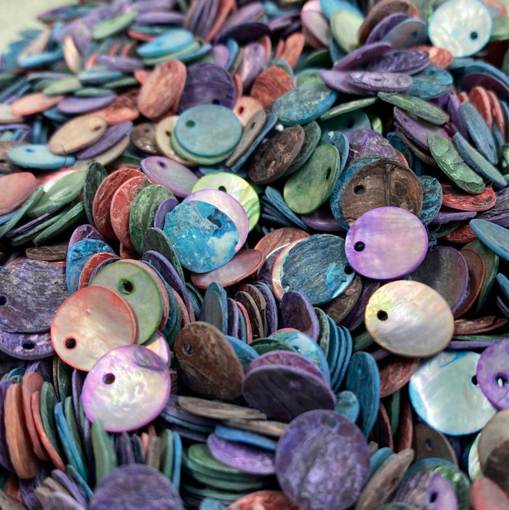 A collection of multicolored real shell beads with a hole on the edge for stringing purposes, used for crafting and jewelry making.
