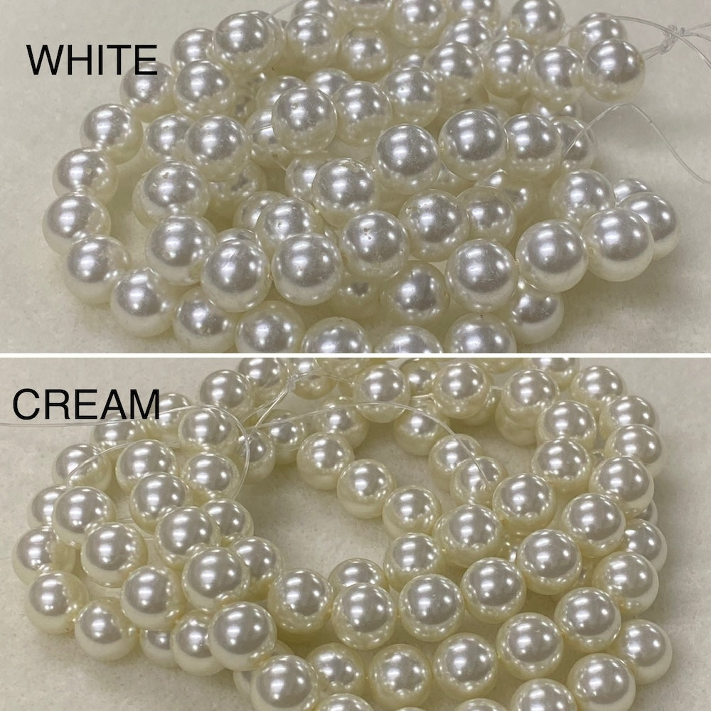 Two strands of pearls labeled 'White' and 'Cream' on a neutral background.