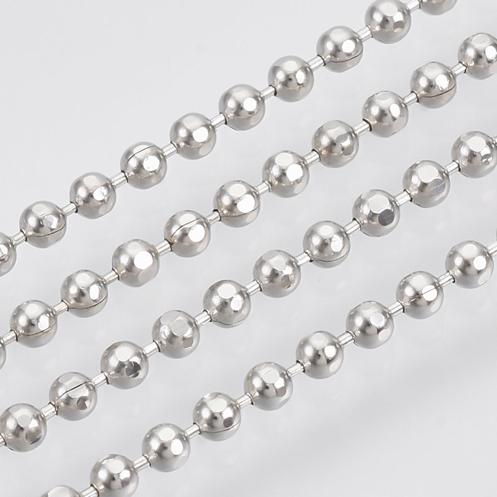 A roll of ball chain with metal balls linked together, along with a close-up view showing the texture and size of the balls.