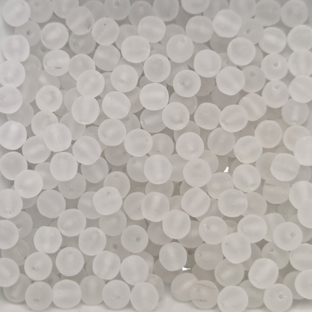 Close-up of translucent white beads on a white background