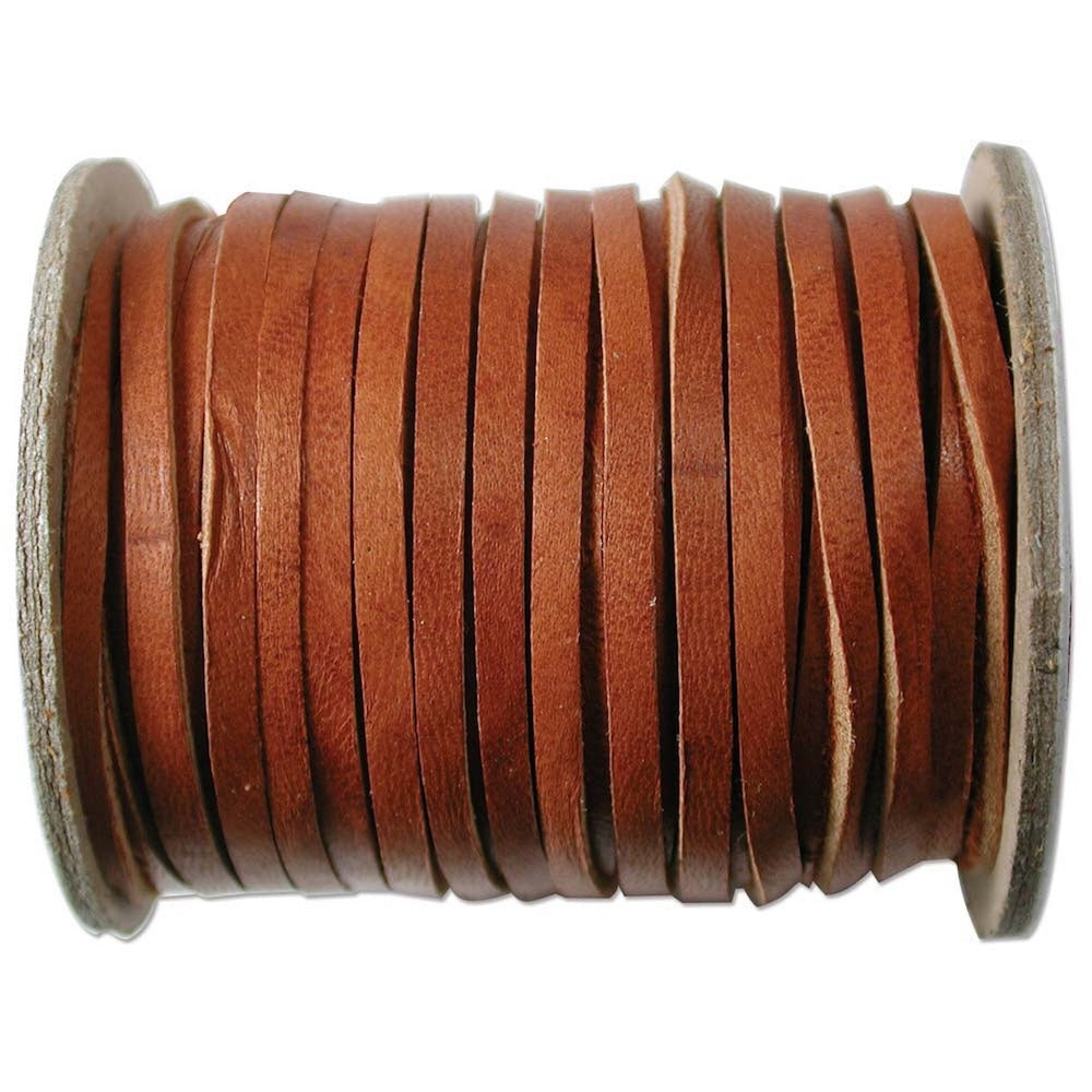 Spool of brown leather deer skin lace on a white background