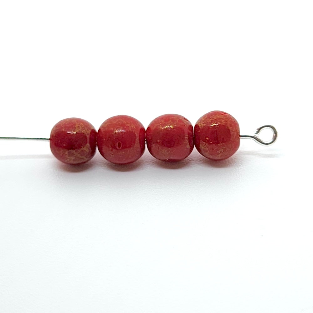 Four red beads on a white background