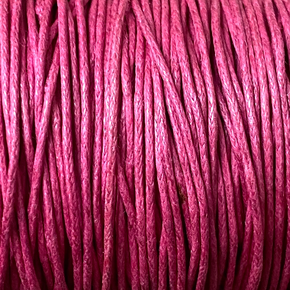 Close-up of dark pink wax cotton strands