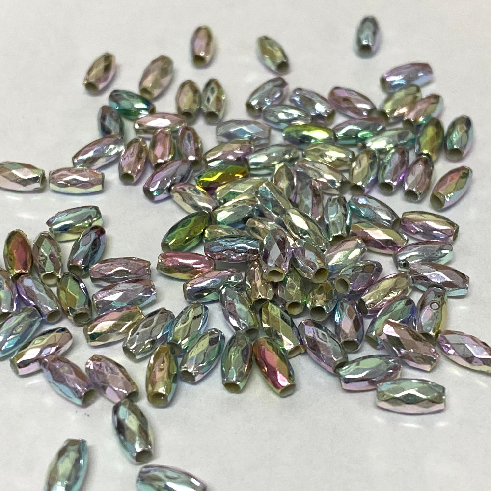 A collection of pastel rainbow colored faceted rice-shaped acrylic beads scattered on a surface.