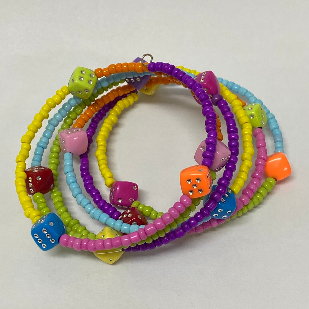 Colorful beaded bracelets with dice charms on a light gray background