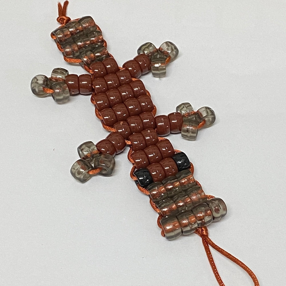 beaded platypus australian animal shape using brown and grey pony beads on a white background