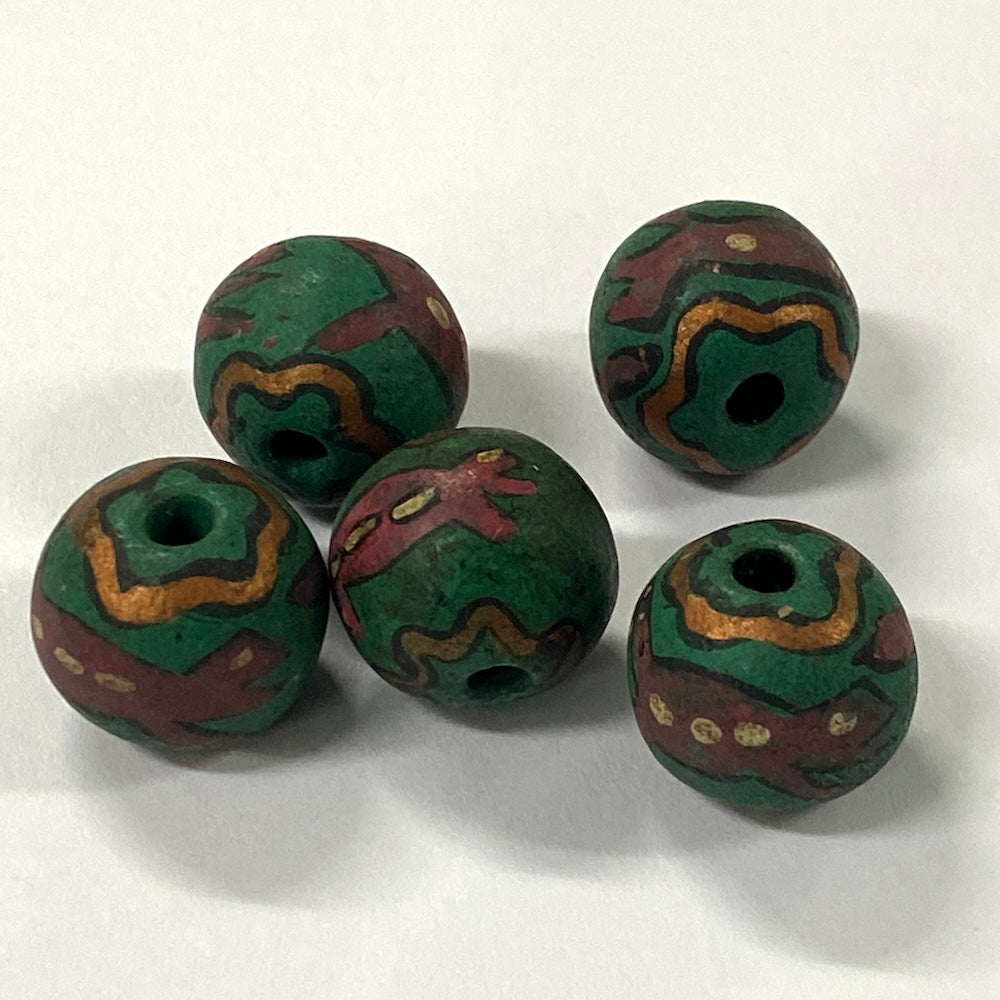 Five green and brown patterned vintage ceramic beads with lizards on a white background