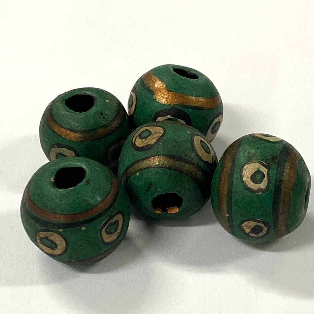 Green vintage ceramic beads with gold accents on a white background