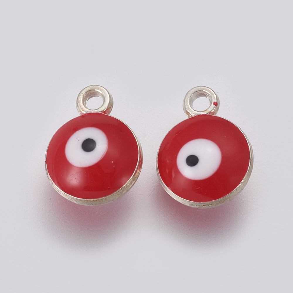 Two red evil eye charms with silver borders on a white background
