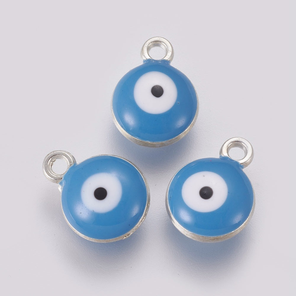 Three blue evil eye charms with silver loops on a light gray background