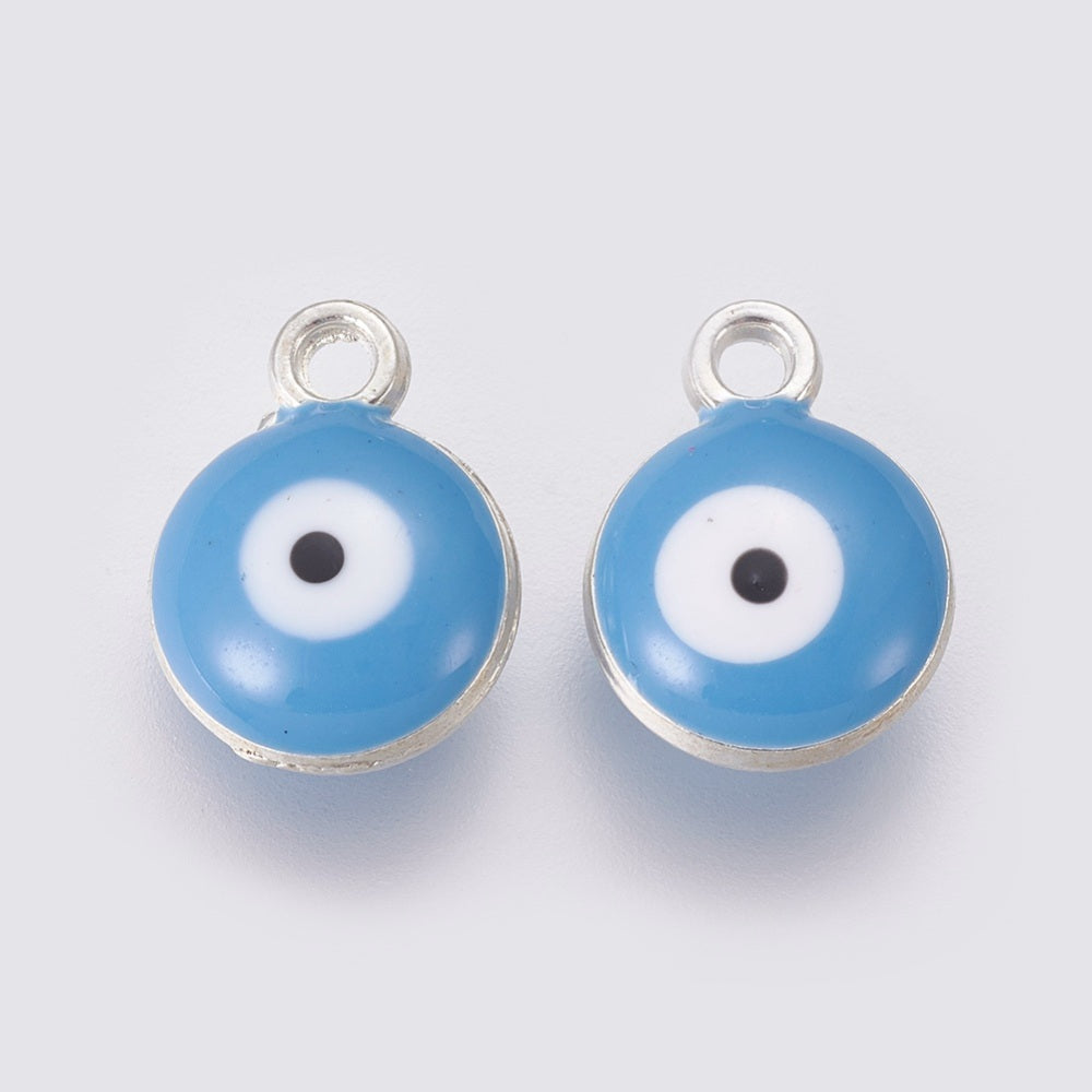 Two blue evil eye charms with silver loops on a light gray background
