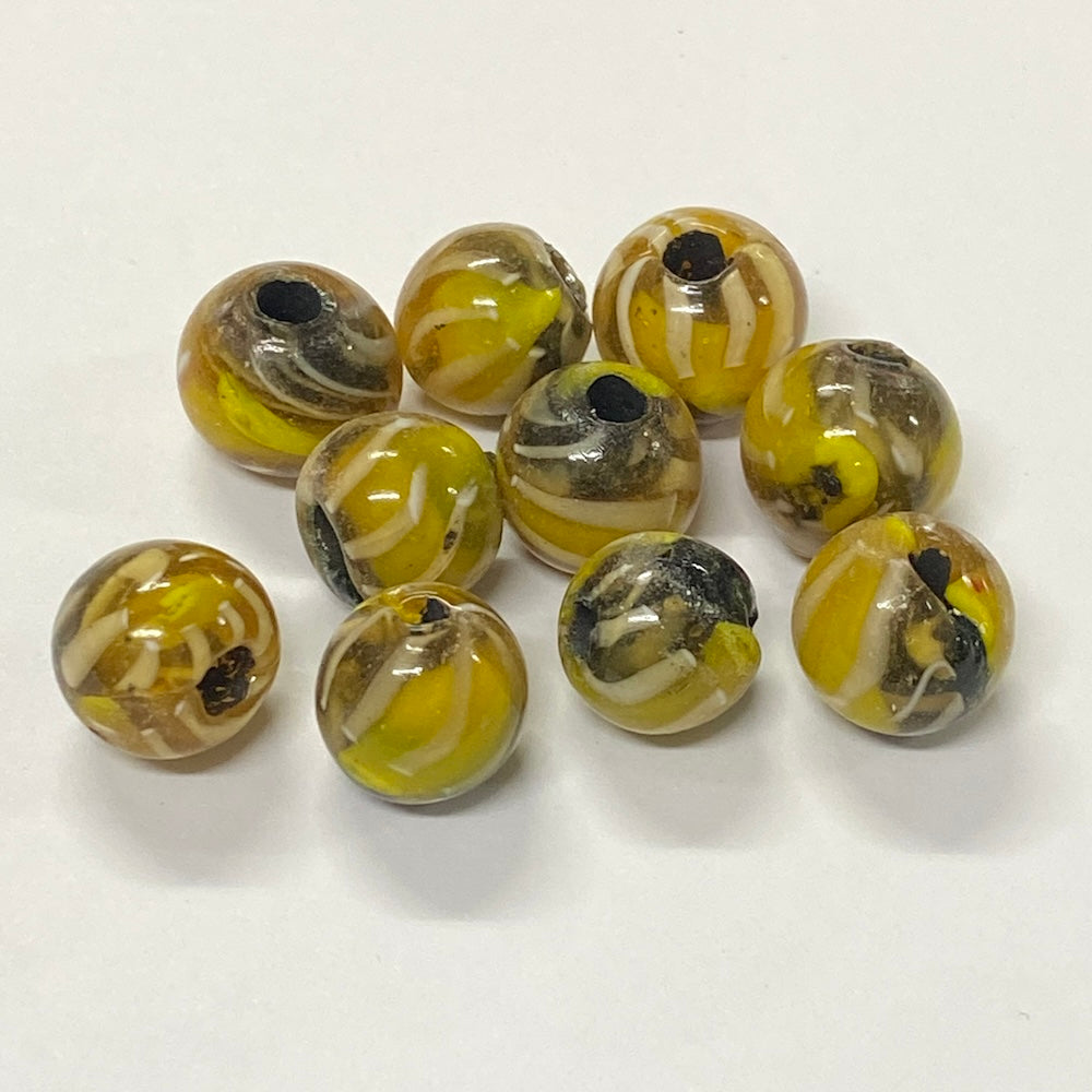 Set of yellow and black marbled beads on a white background