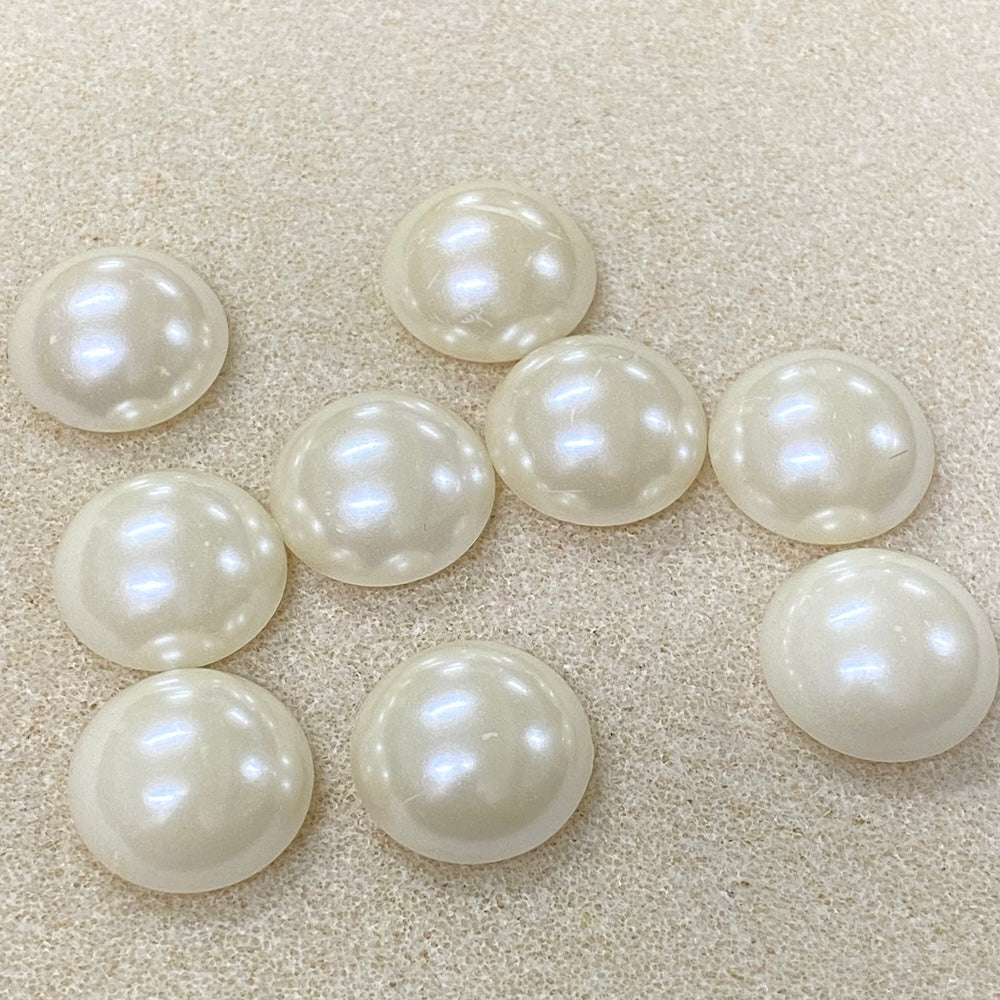 Pearl-like beads on a beige surface