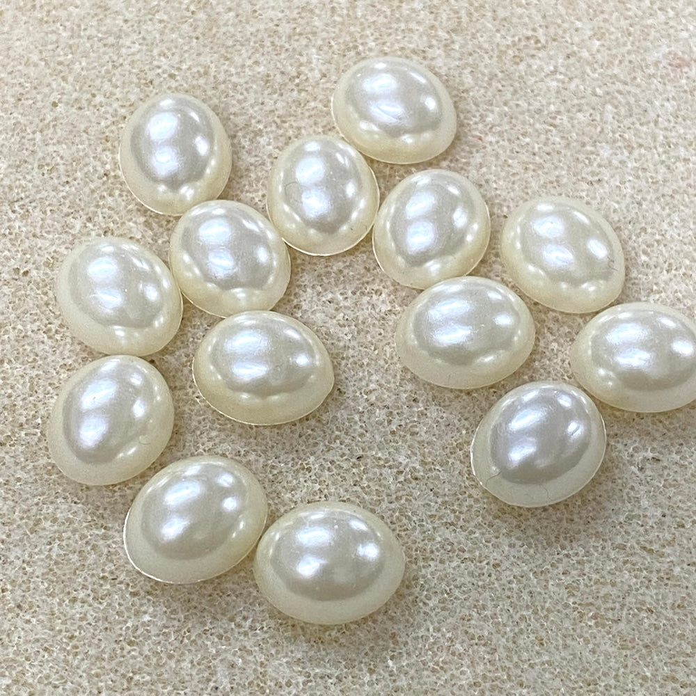 Pearl stones on a textured beige surface