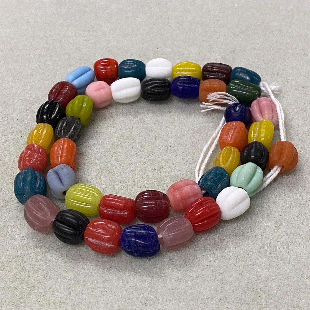 Colorful glass beads on a textured surface