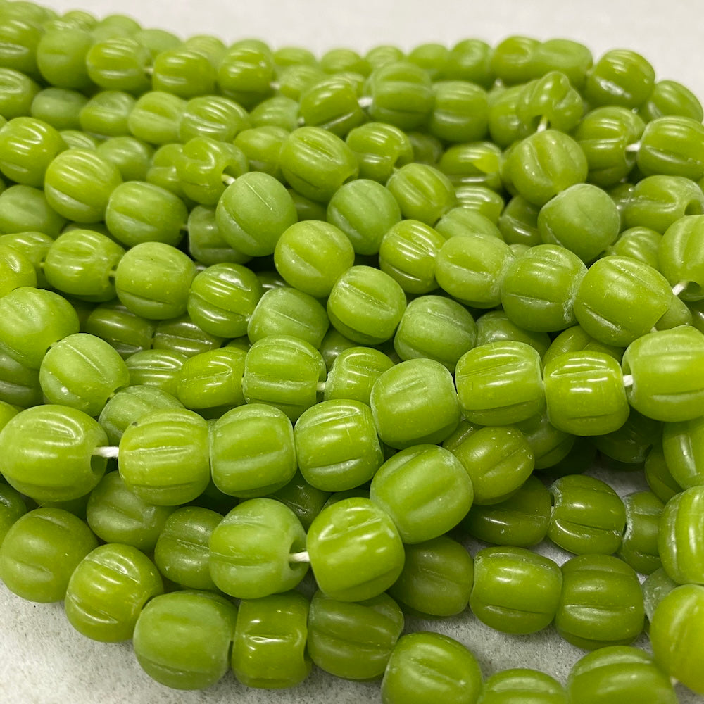 Close-up of green beads on a white background