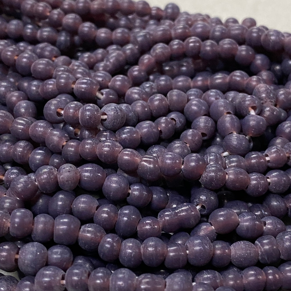 Close-up of purple beads on a white background