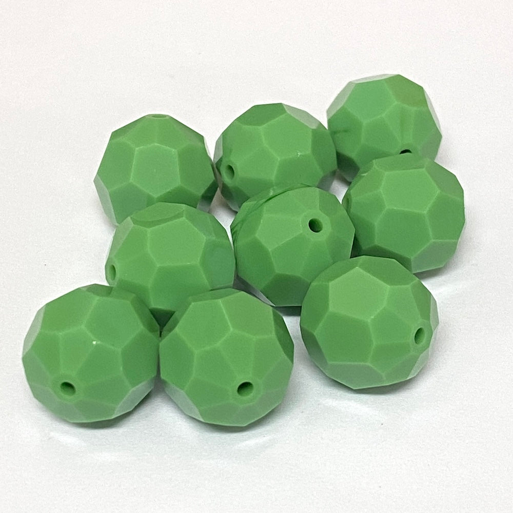 faceted green crystal beads on a white background