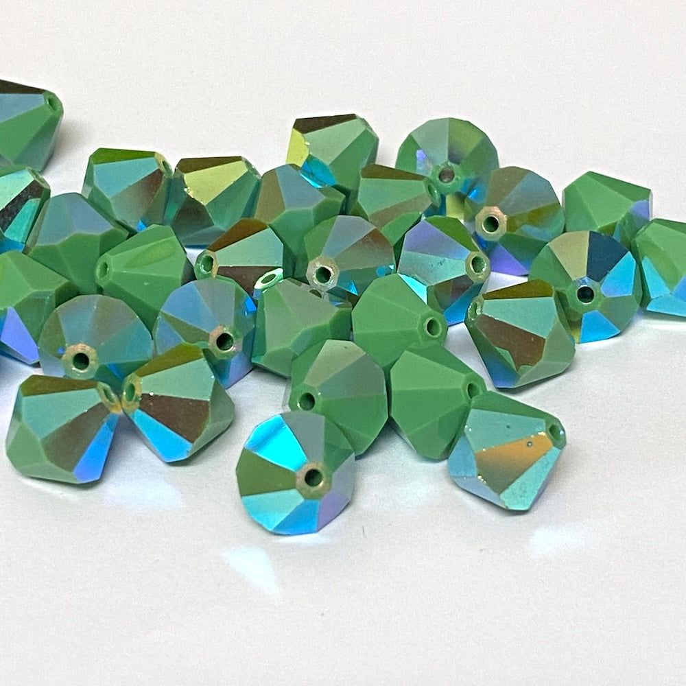 faceted green crystal beads on a white background