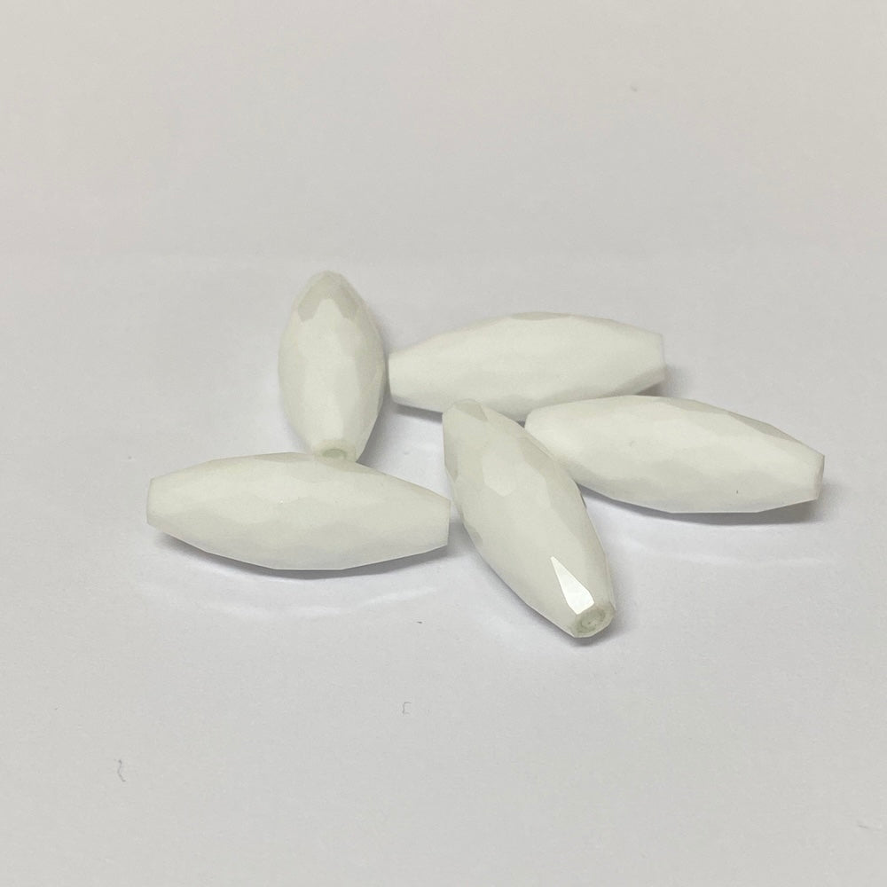 white faceted crystal beads on a grey background