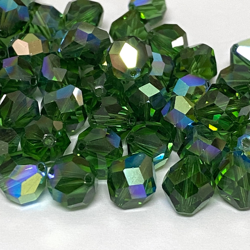 faceted green crystal beads on a white background