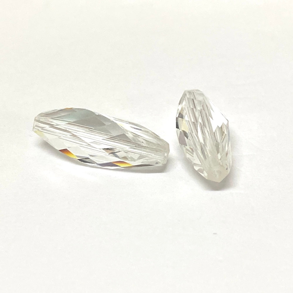 Two clear crystal faceted beads on a white background