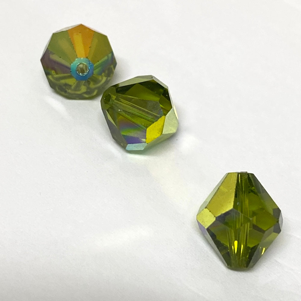 Green faceted crystal beads on a white background