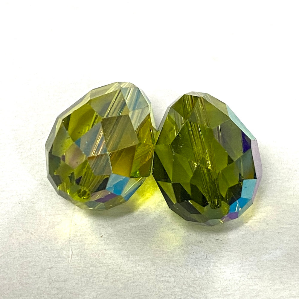 Green faceted crystal pear shape bead on a white background