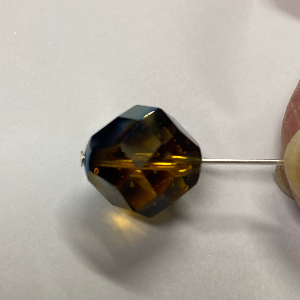 Faceted brown crystal bead on a white background