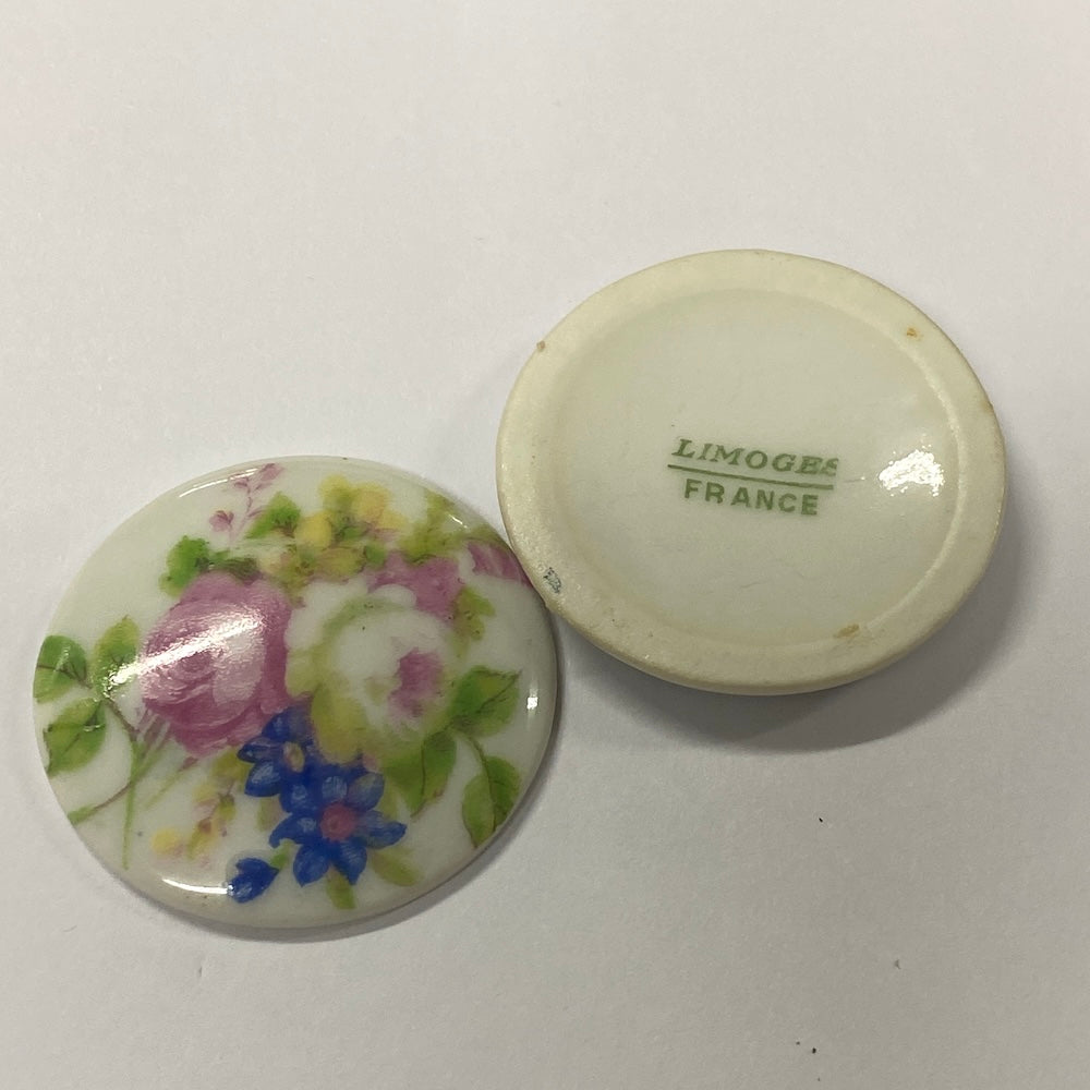 Two round ceramic items with floral design and 'Limoges France' text on a white background