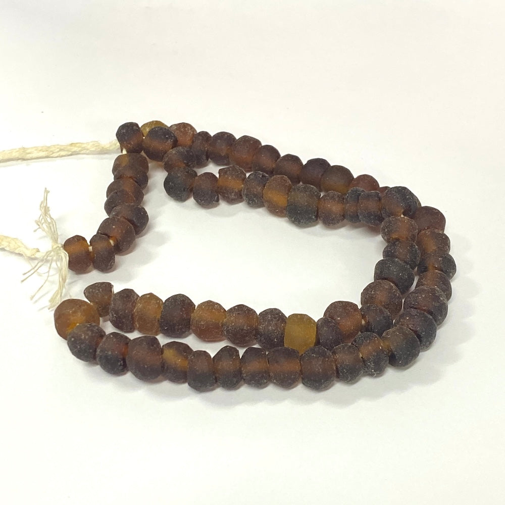 String of brown beads on a white background