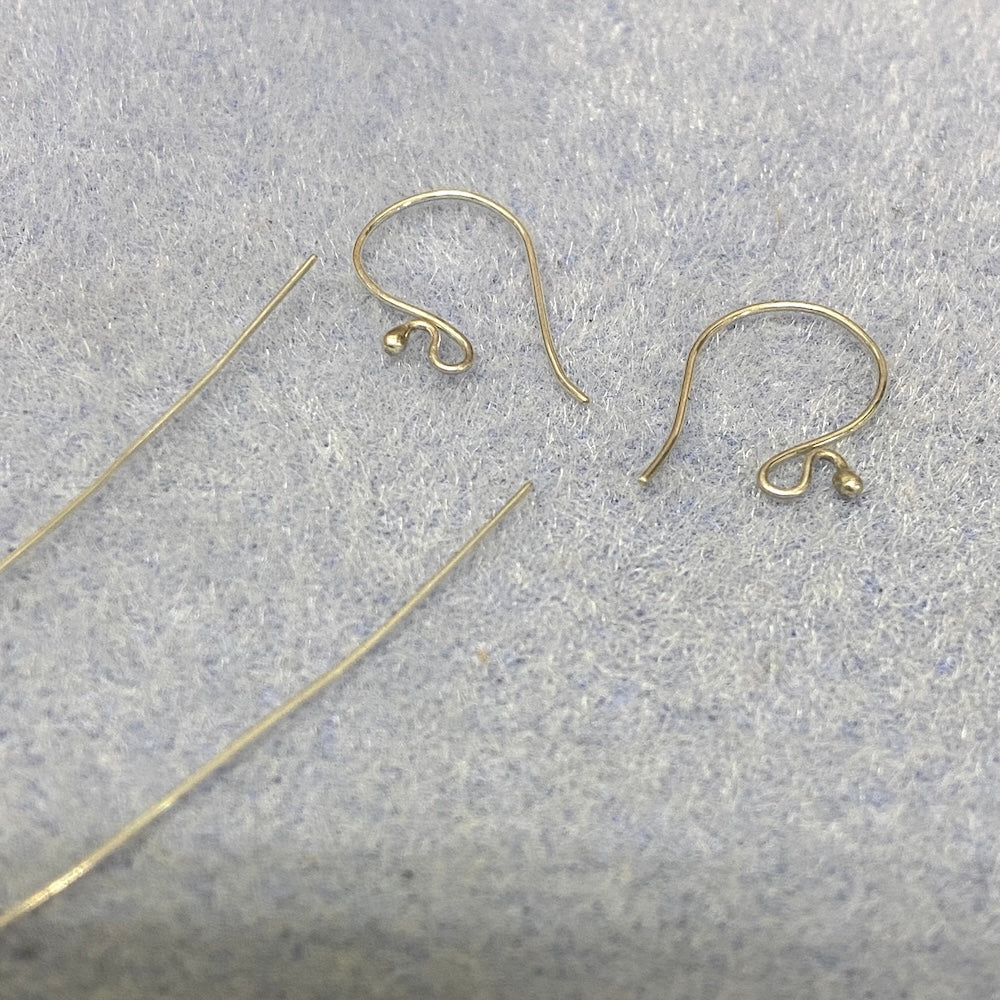 Sterling Silver Bali earring hooks and wires on a gray surface