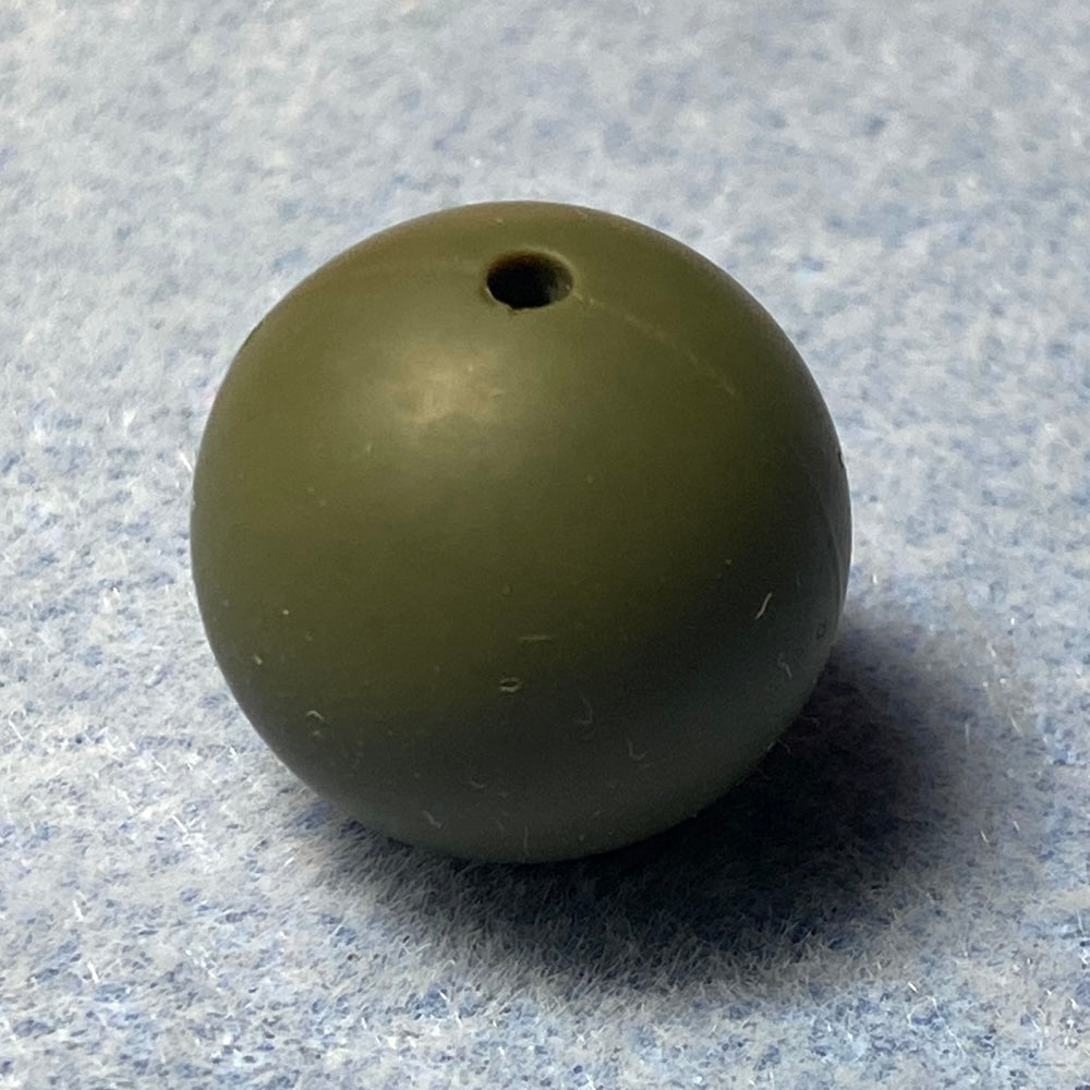Green silicone bead on a textured gray background