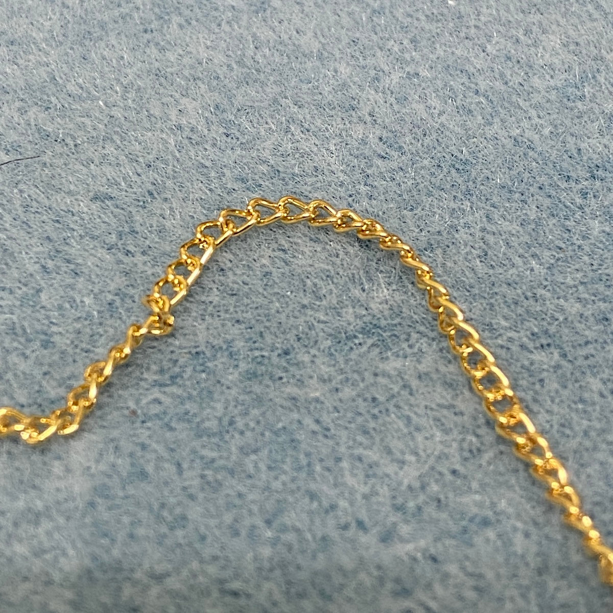 Gold chain on a gray textured background