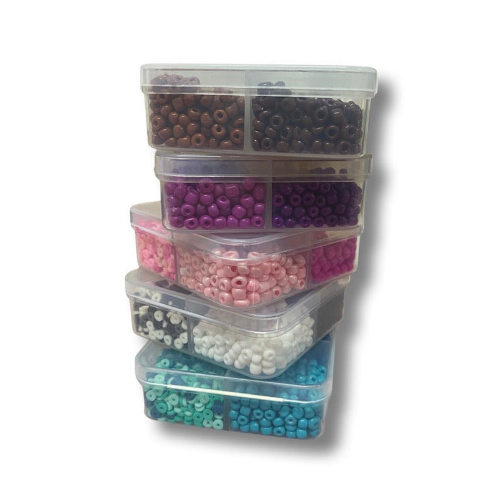 Small plastic compartment boxes holding colourful beads for the purpose of children making beaded projects and craft